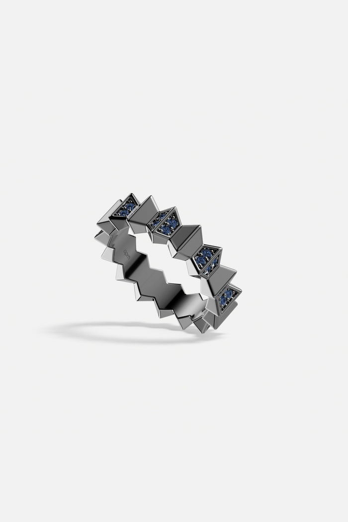 APM Ring in dark rhodium finish, zigzag edges with deep blue sparkle.