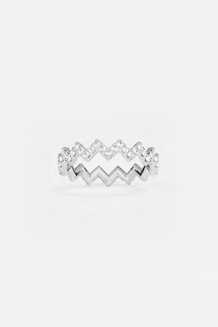 APM Ring, zigzag rhythm in rhodium finish, sparkling with effortless modern grace.