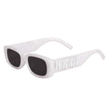 White Wifey sunglasses with dark lenses and embossed temple detail on neutral background